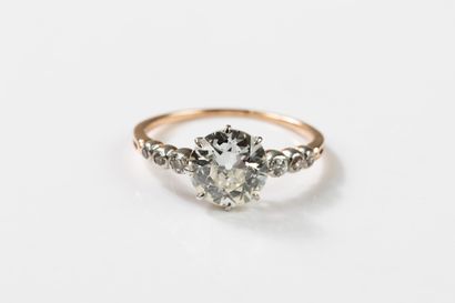 Gold and platinum ring centered on an old-cut...