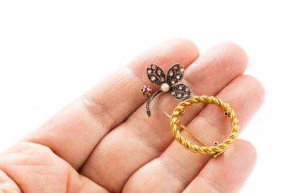 Brooch holding a removable silver floral...