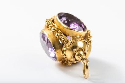 Gold pendant featuring a lantern set with...