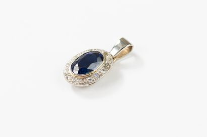 Gold pendant set at its center with a synthetic...