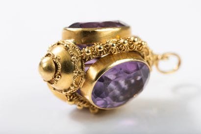 Gold pendant featuring a lantern set with...