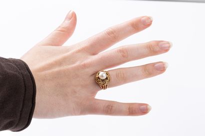 Yellow gold ring centered with a cultured...