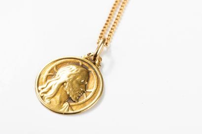 Gold chain with a gold medal depicting Christ...
