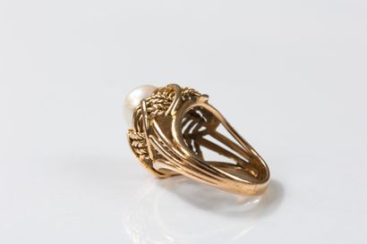 Yellow gold ring centered with a cultured...
