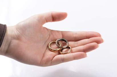 Three rings, one in yellow, one in pink and...