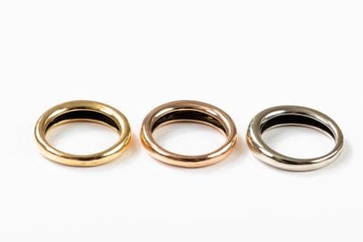 Three rings, one in yellow, one in pink and...