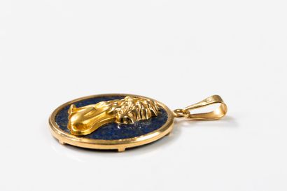 Round lapis lazuli pendant set with a gold...