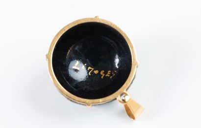 Yellow gold pendant adorned with a blue and...