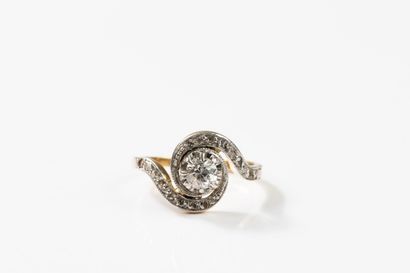 Yellow and white gold ring centered on an...