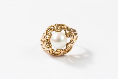 Yellow gold ring centered with a cultured...