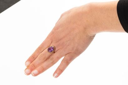 Yellow gold ring set with an oval synthetic...