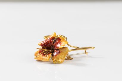 Yellow gold brooch featuring a flower with...