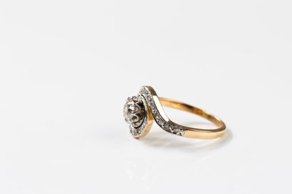 Yellow and white gold ring centered on an...