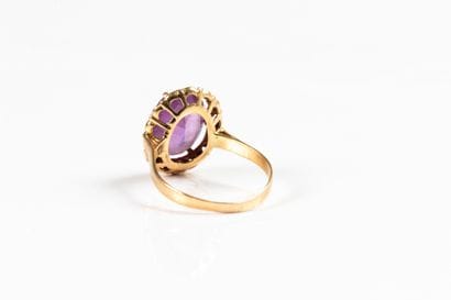 Yellow gold ring set with an oval synthetic...