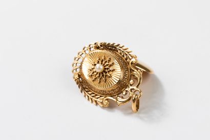 Medallion pendant topped with a pearl in...