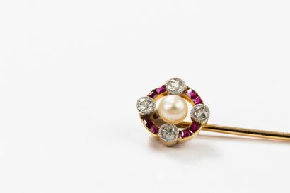 Gold tie pin featuring a circular motif centered...