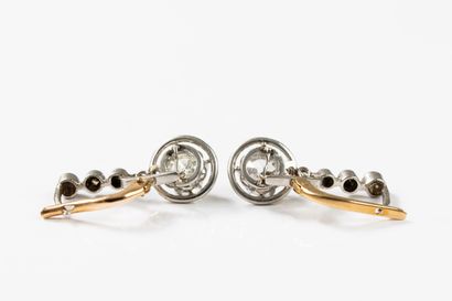 Pair of earrings adorned with three diamonds...