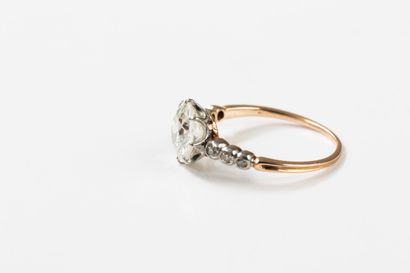 Gold and platinum ring centered on an old-cut...