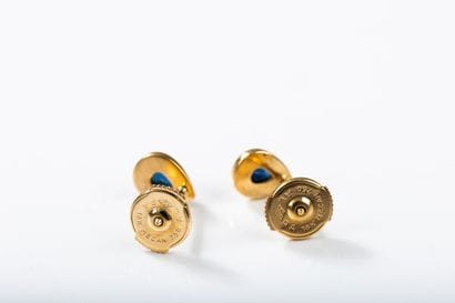 Pair of pear-shaped gold earrings centered...