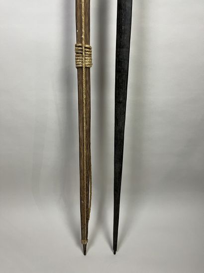 Two bows: A palm wood bow with a light cotton...