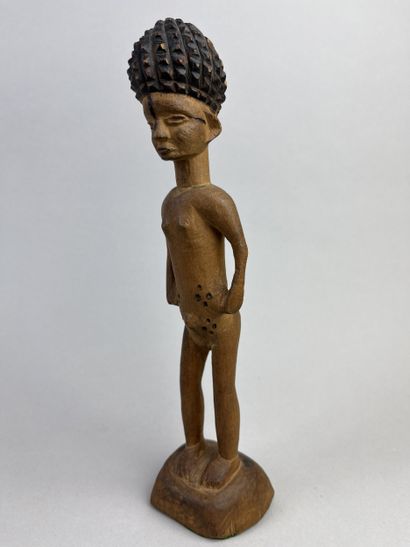 Statuette depicted standing on a round base,...
