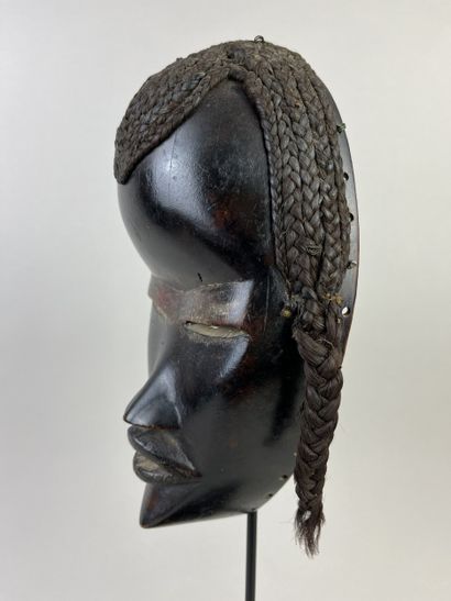 Mask with human face, a wolf painted black...