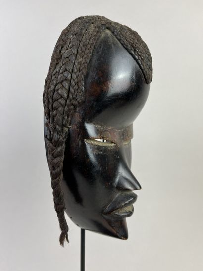 Mask with human face, a wolf painted black...