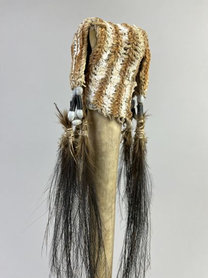 Dagger adorned at the top with a fiber cap...
