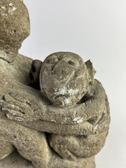 Sculpture depicting a simian figure holding...