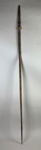Long stick (or stylized arrow) carved with...
