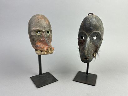 Two diminutive masks. Wood with earthy patina,...