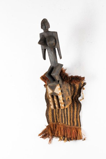 Satimbe mask surmounted by a standing female...