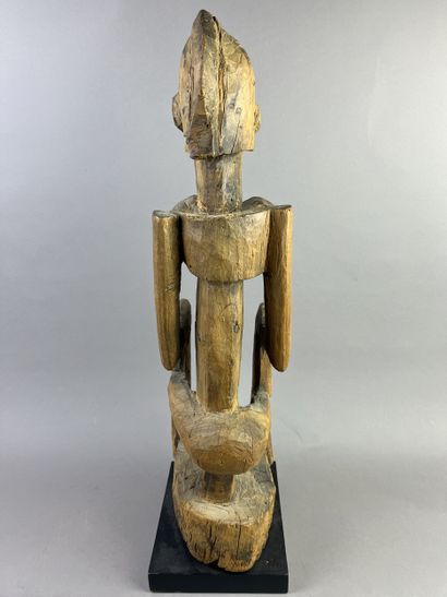 Cubist-style female statue, shown seated...