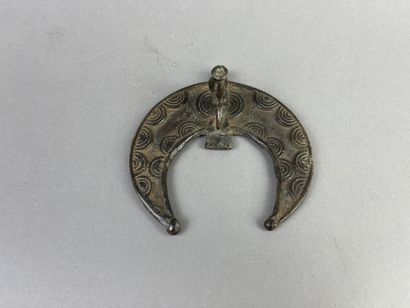 Crescent-shaped pendant with hornbill head....