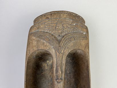 Pirogue scoop carved with a stylized human...