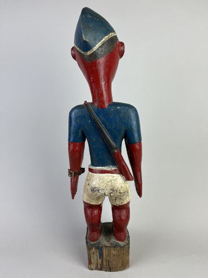 Colon statuette depicting a standing man...