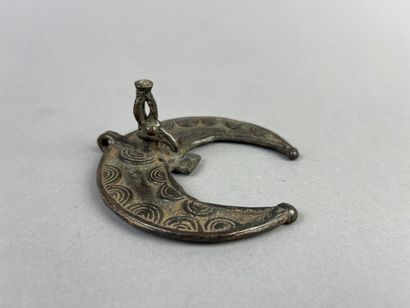 Crescent-shaped pendant with hornbill head....