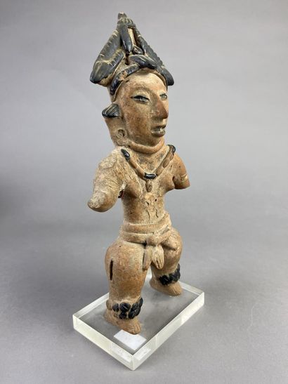 Standing female statuette wearing a cone-shaped...