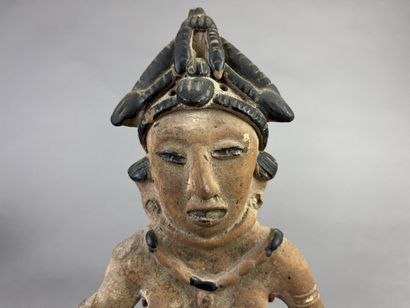 Standing female statuette wearing a cone-shaped...