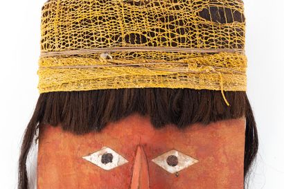 Funerary fardo mask. The rounded face features...