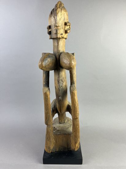 Cubist-style female statue, shown seated...