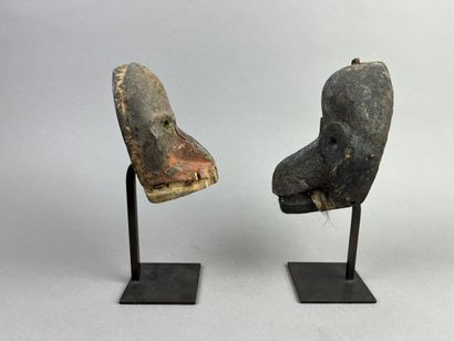 Two diminutive masks. Wood with earthy patina,...