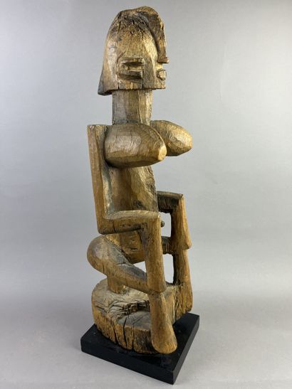 Cubist-style female statue, shown seated...