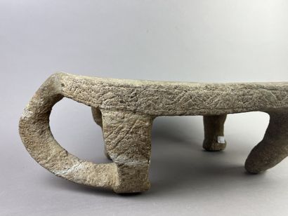 Metate. Corn grinding table in the shape...