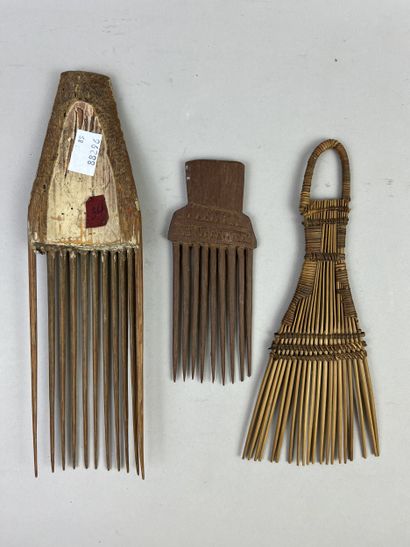 Three combs: one with eleven teeth (one missing)...