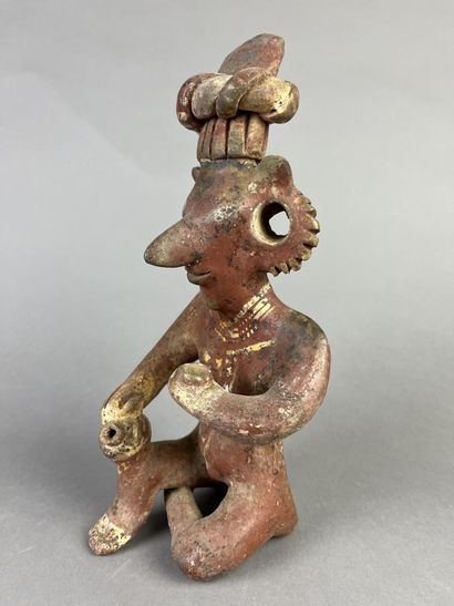 Seated figure, one knee on the ground, holding...