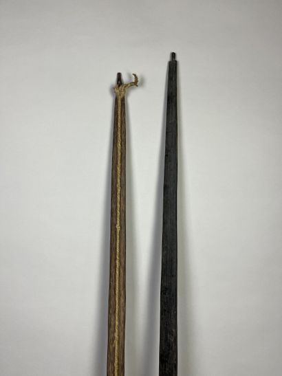 Two bows: A palm wood bow with a light cotton...