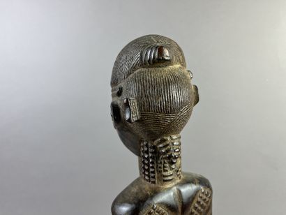 Male ancestor shown standing, holding a long...