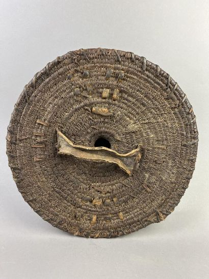 Round wickerwork dance shield with leather-covered...