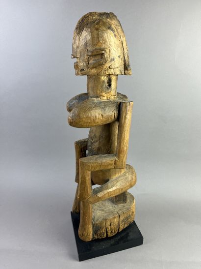 Cubist-style female statue, shown seated...